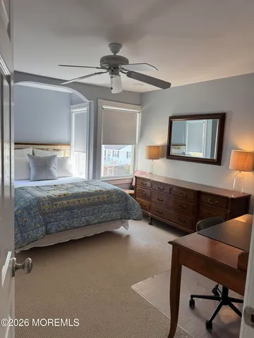 a bedroom with a bed window and a desk