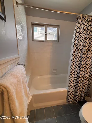 a bathroom with a bathtub and shower