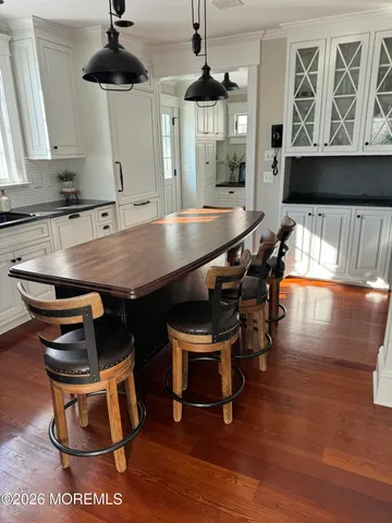 a dining room with furniture and wooden floor