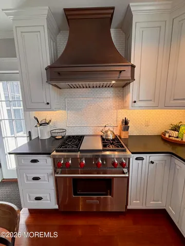 a stove top oven sitting inside of a kitchen