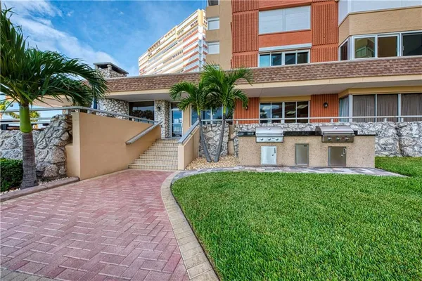 a view of a building with a garden and plants