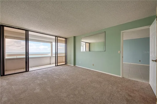 an empty room with windows and closet
