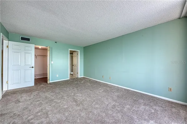 an empty room with closet area