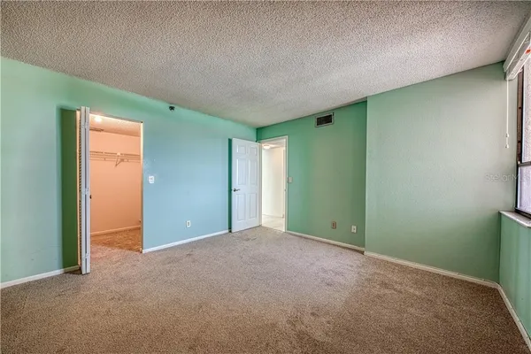 an empty room with closet area