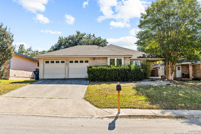 a view of house with swimming pool and a yard