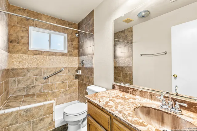 a bathroom with a sink toilet and shower