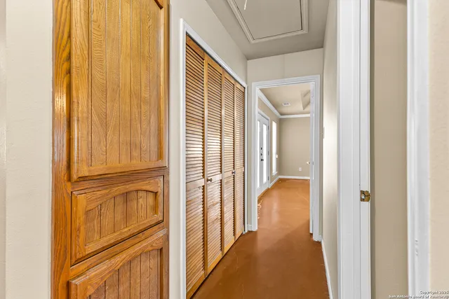 a view of walk in closet with view of bathroom