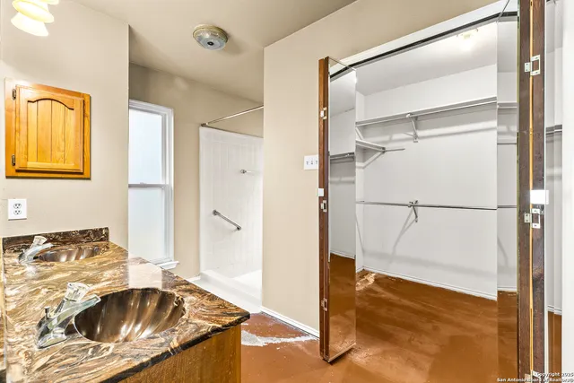 a bathroom with a tub sink and a mirror