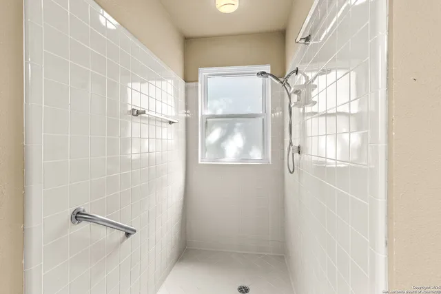 a bathroom with a glass shower door
