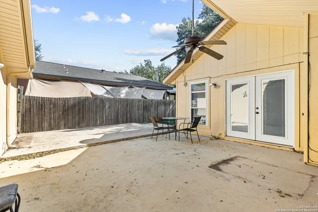 a backyard of a house with table and chairs