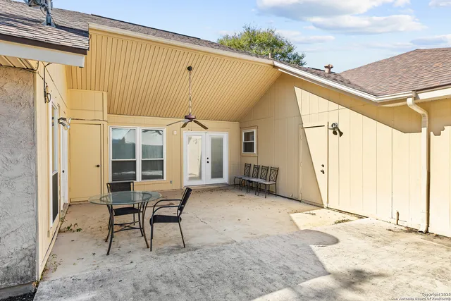 a backyard of a house with table and chairs