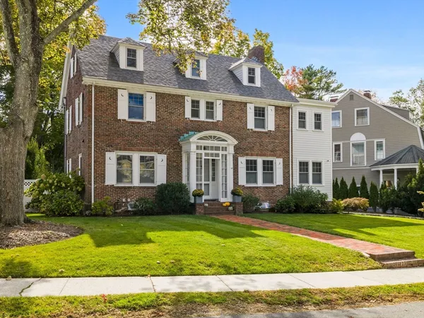 a front view of a house with a yard