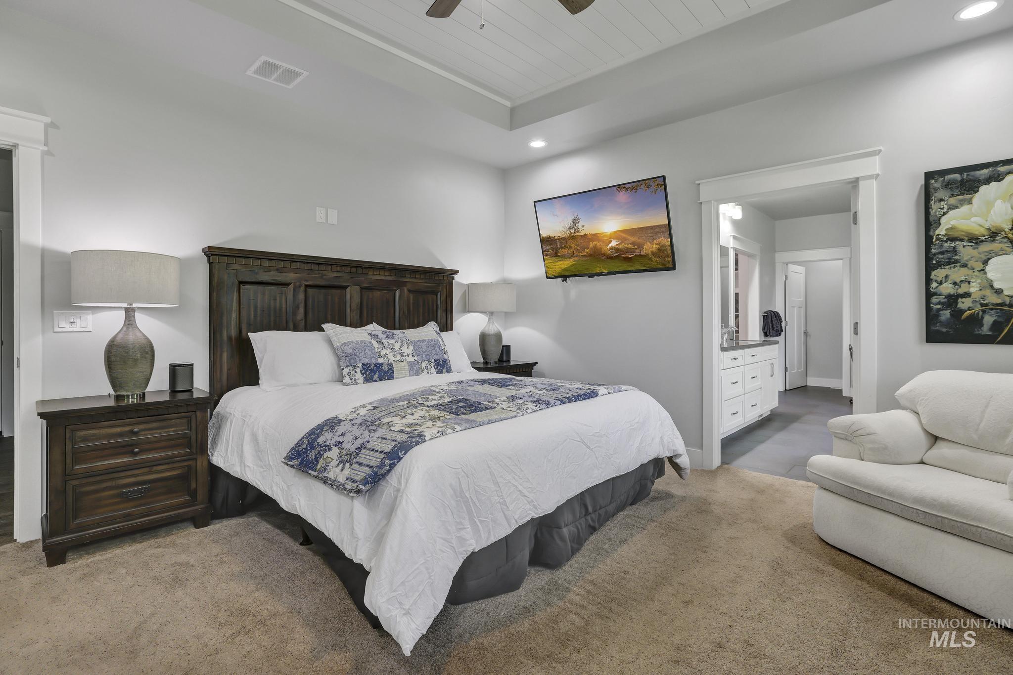1937 Tamarack Loop Twin Falls, ID 83301 - Photo 32 of 50 Spacious bedroom featuring recessed lighting, a tray ceiling with wood-panel detailing, and carpet flooring