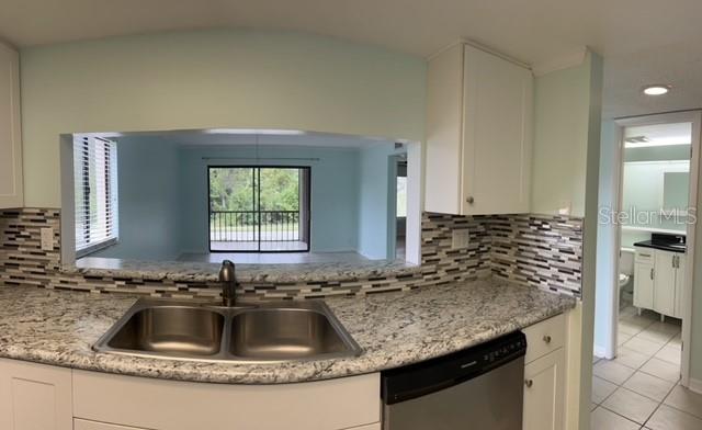 2737 Enterprise Road East, Unit 152 Clearwater, FL 33759 - Photo 11 of 33 a kitchen with granite countertop a sink and a granite counter tops