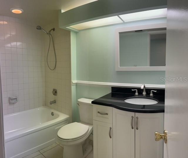 2737 Enterprise Road East, Unit 152 Clearwater, FL 33759 - Photo 15 of 33 a bathroom with a granite countertop sink toilet a mirror and shower