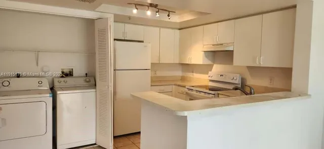 a white refrigerator freezer sitting inside of a kitchen