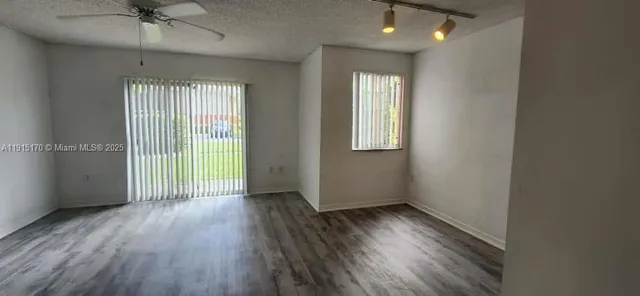 an empty room with wooden floor and a window