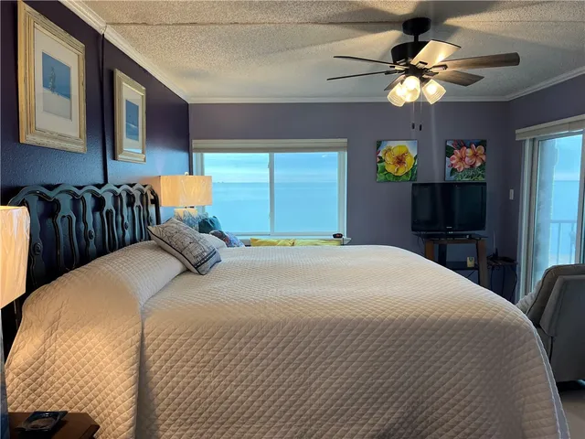 a bedroom with a bed and ceiling fan