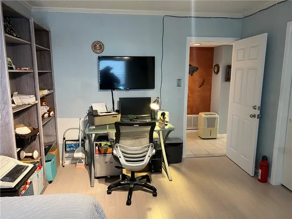 a work room with furniture and a flat screen tv