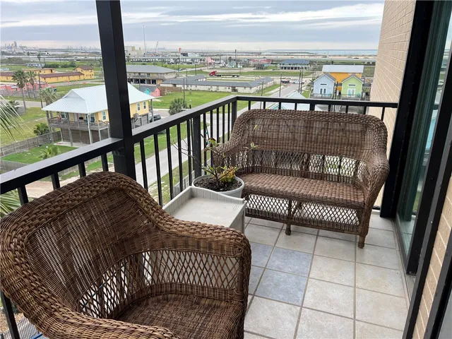 a view of a balcony with furniture