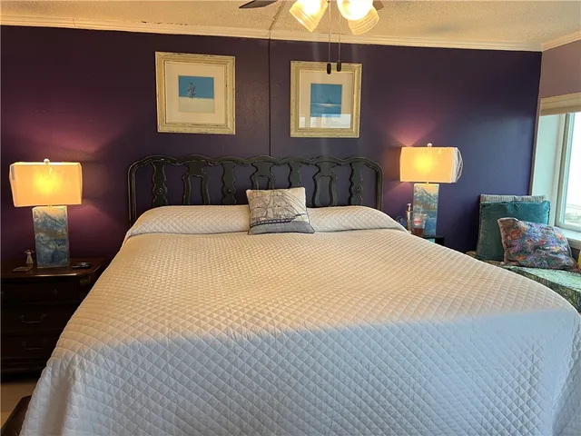 a bedroom with a bed and a lamp