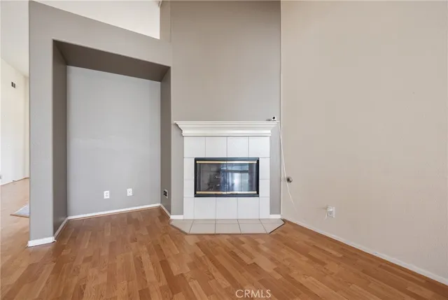 a view of a livingroom with a fireplace and wooden floor