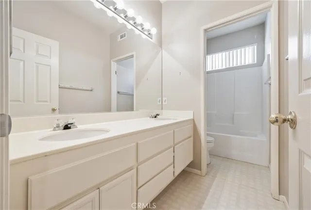 a spacious bathroom with a bathtub and a sink