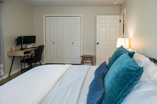 a bedroom with a bed and a flat screen tv