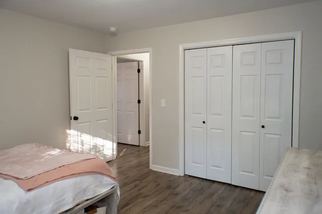 a view of a room with wooden floor cabinet and bathroom