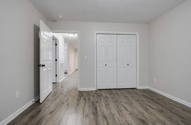 a view of a hallway with wooden floor
