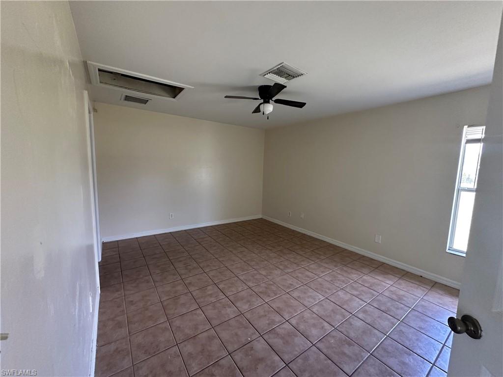 3965 20th Street West Lehigh Acres, FL 33971 - Photo 12 of 18 a view of a room with a window and a ceiling fan
