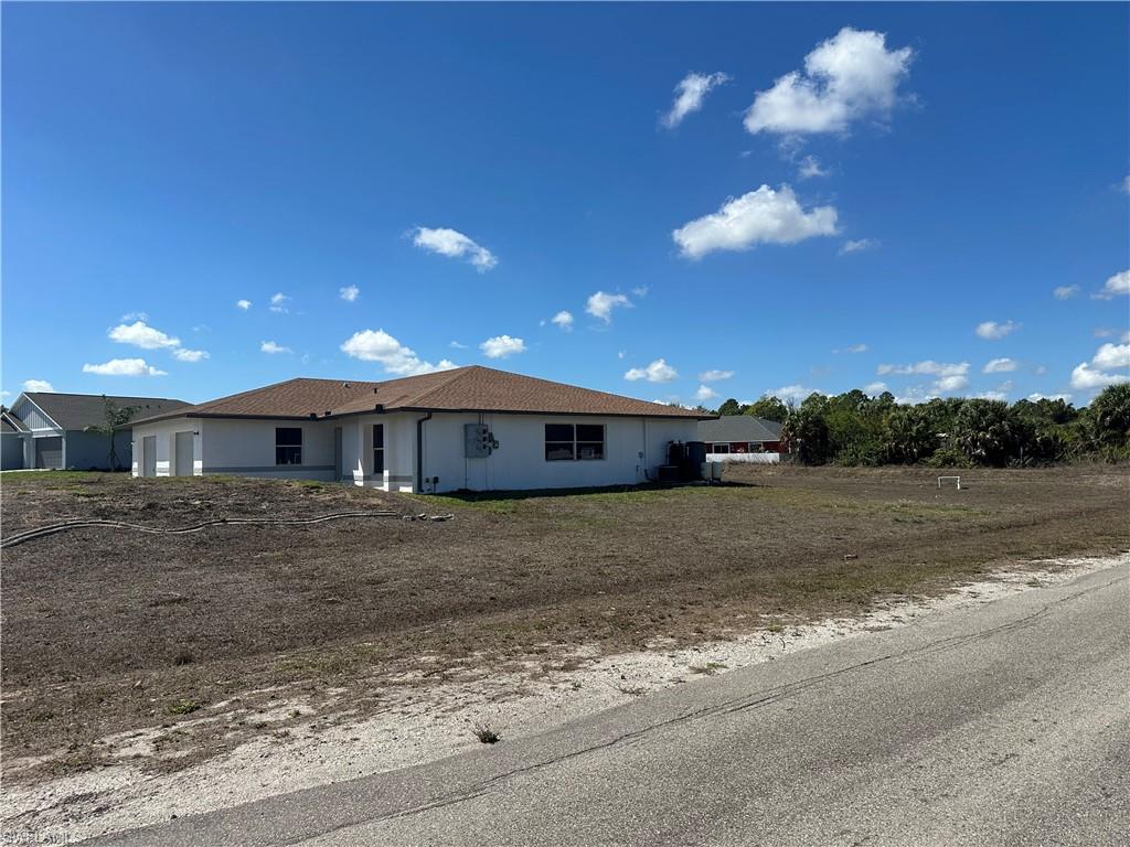 3965 20th Street West Lehigh Acres, FL 33971 - Photo 16 of 18 a view of a house with a yard