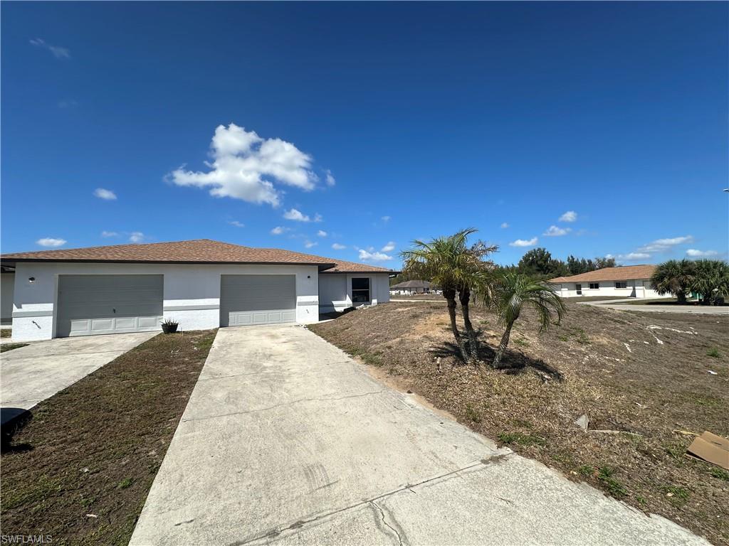 3965 20th Street West Lehigh Acres, FL 33971 - Photo 18 of 18 a front view of a house with a yard
