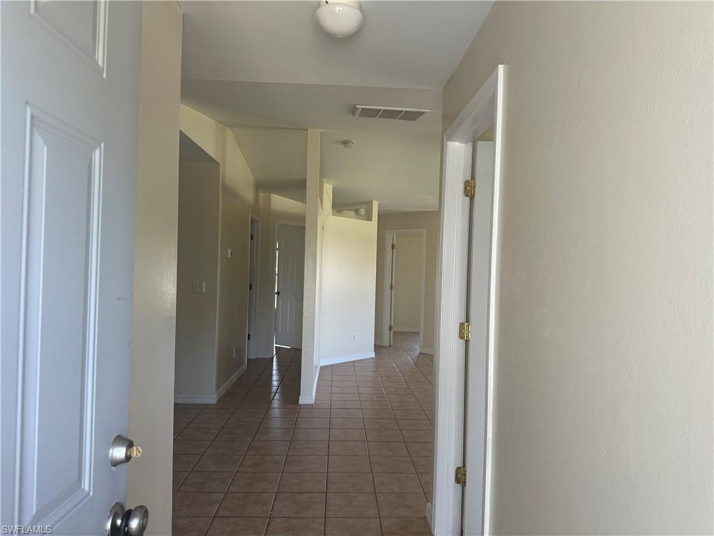 3965 20th Street West Lehigh Acres, FL 33971 - Photo 3 of 18 a view of a hallway with wooden shelves