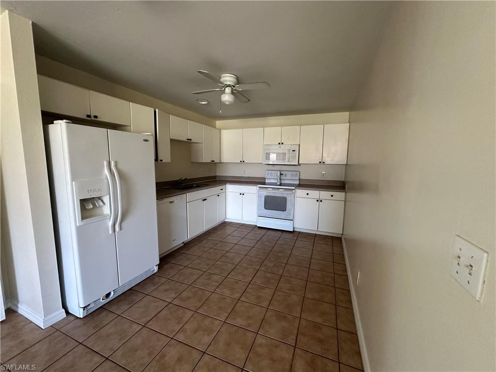 3965 20th Street West Lehigh Acres, FL 33971 - Photo 8 of 18 a kitchen with stainless steel appliances a refrigerator sink and microwave