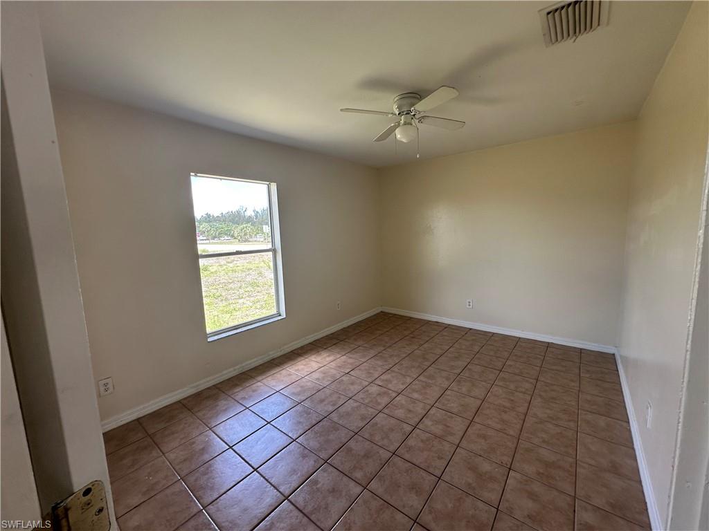 3965 20th Street West Lehigh Acres, FL 33971 - Photo 9 of 18 an empty room with windows and fan