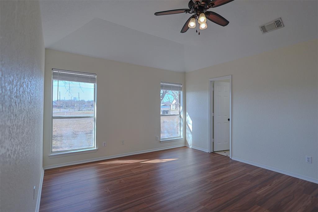 7848 Nine Mile Bridge Road Fort Worth, TX 76135 - Photo 11 of 36 a view of an empty room with a window and wooden floor