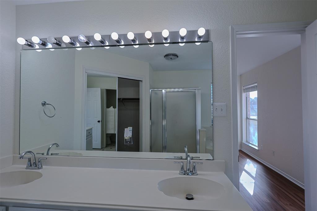 7848 Nine Mile Bridge Road Fort Worth, TX 76135 - Photo 13 of 36 a bathroom with a double vanity sink and a mirror