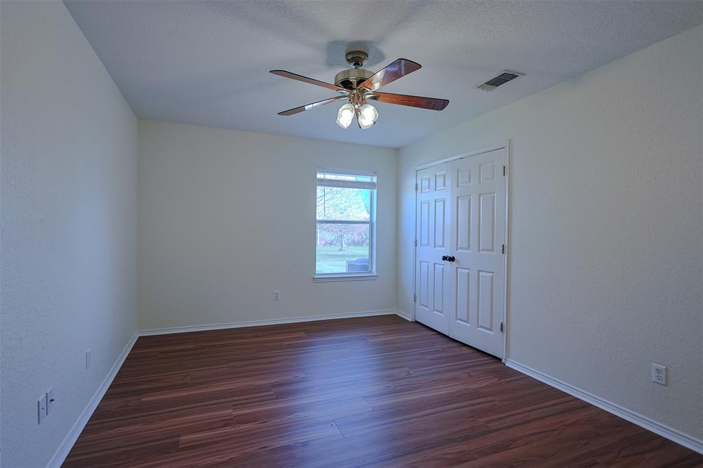 7848 Nine Mile Bridge Road Fort Worth, TX 76135 - Photo 19 of 36 a view of an empty room with wooden floor and a window