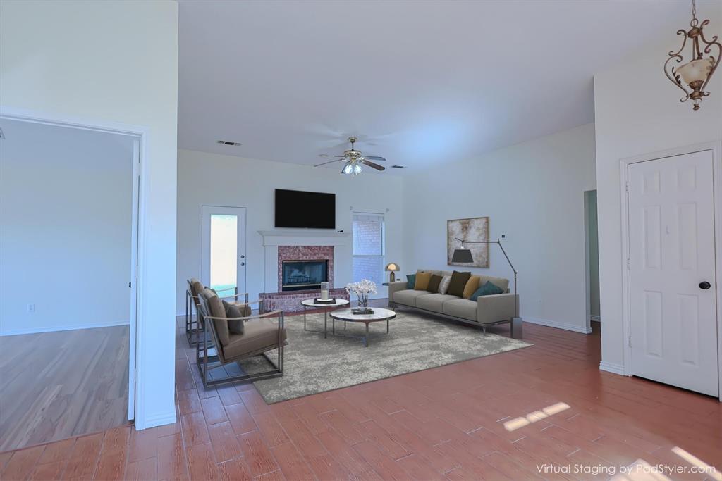 7848 Nine Mile Bridge Road Fort Worth, TX 76135 - Photo 4 of 36 a living room with furniture and a fireplace