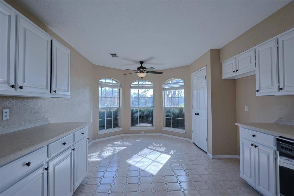 7848 Nine Mile Bridge Road Fort Worth, TX 76135 - Photo 7 of 36 a large kitchen with cabinets and a wooden floors