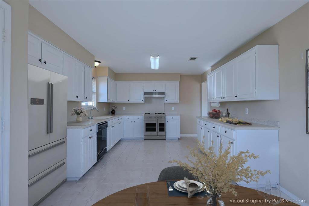 7848 Nine Mile Bridge Road Fort Worth, TX 76135 - Photo 9 of 36 a large kitchen with stainless steel appliances kitchen island granite countertop a refrigerator and a stove top oven