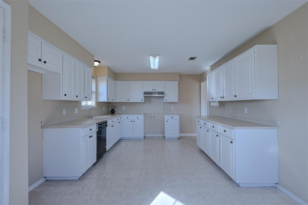 7848 Nine Mile Bridge Road Fort Worth, TX 76135 - Photo 10 of 36 a large kitchen with cabinets and stainless steel appliances