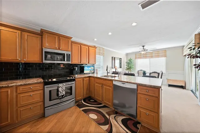 a kitchen with granite countertop a stove top oven and sink