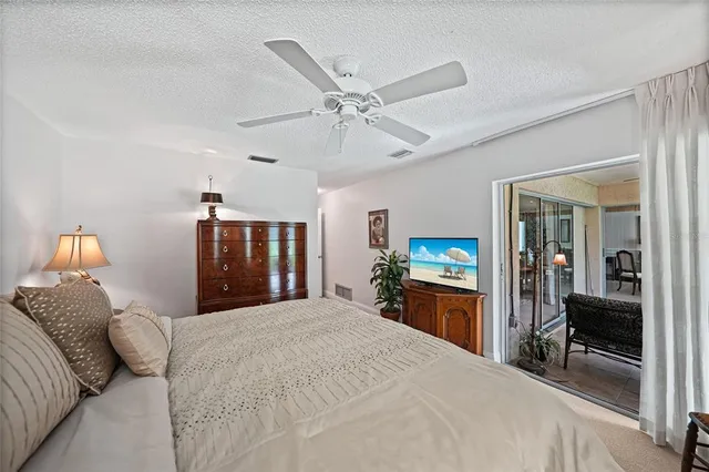 a bedroom with a large bed and a chandelier