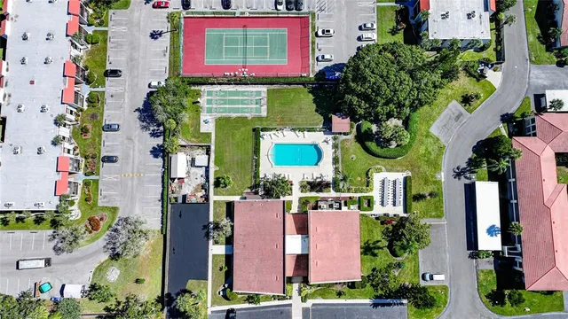 an aerial view of a multi story building with yard