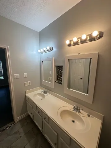 a bathroom with a sink double vanity and a mirror