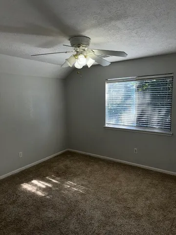 a view of room with window and ceiling fan