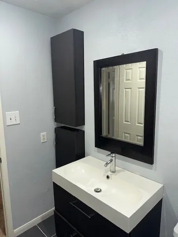 a bathroom with a sink and a mirror