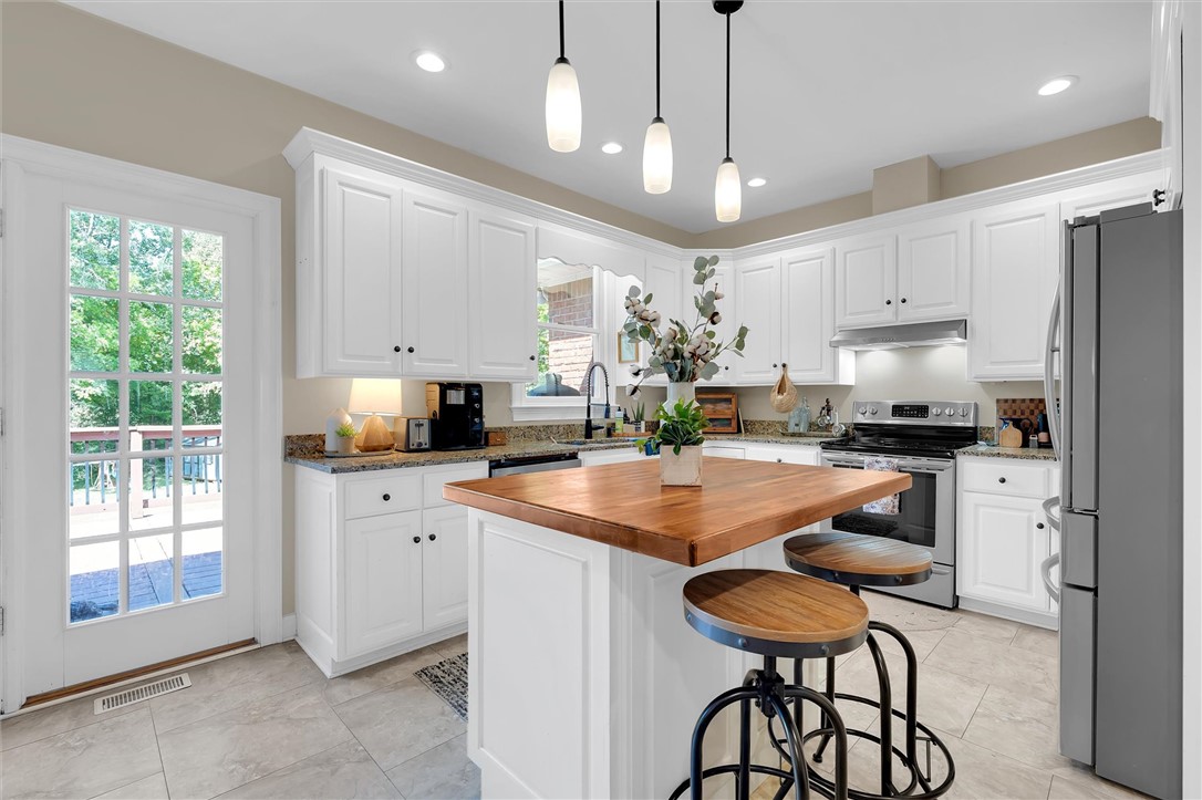 117 Winding Creek Road Anderson, SC 29621 - Photo 10 of 42 This spacious kitchen offers ample storage, bright lighting, and a charming breakfast bar for casual dining.